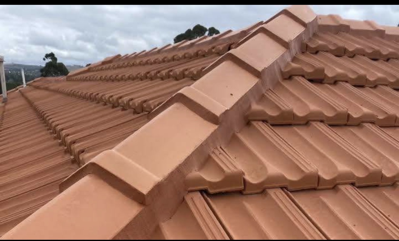 Freshly restored terracotta tile roof with re-pointed ridge capping